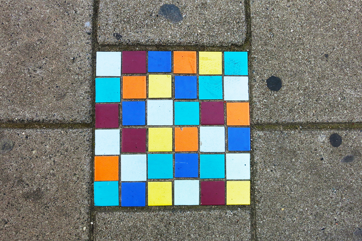 Street tile art on the sidewalk in Amsterdam