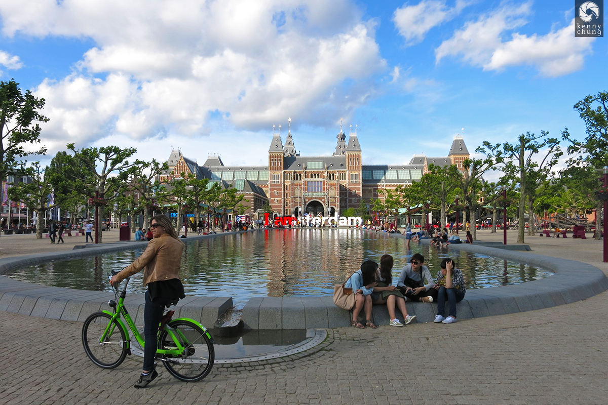 A women riding her bike through Museumplein, Amsterdam