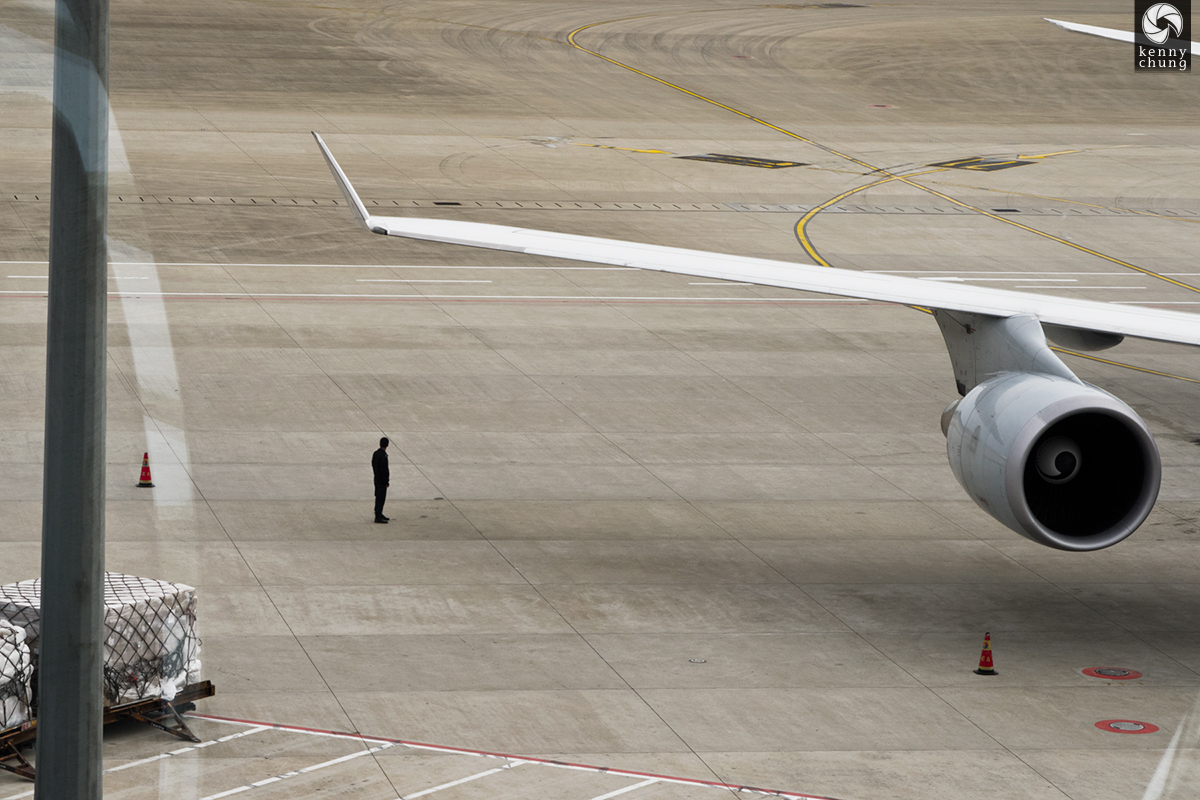 Man on the tarmac at Shanghai Pudong International Airport (PVG)