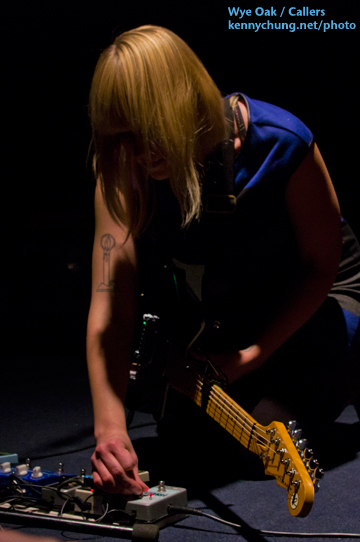 Jenn Wasner adjusting her pedals in between songs.