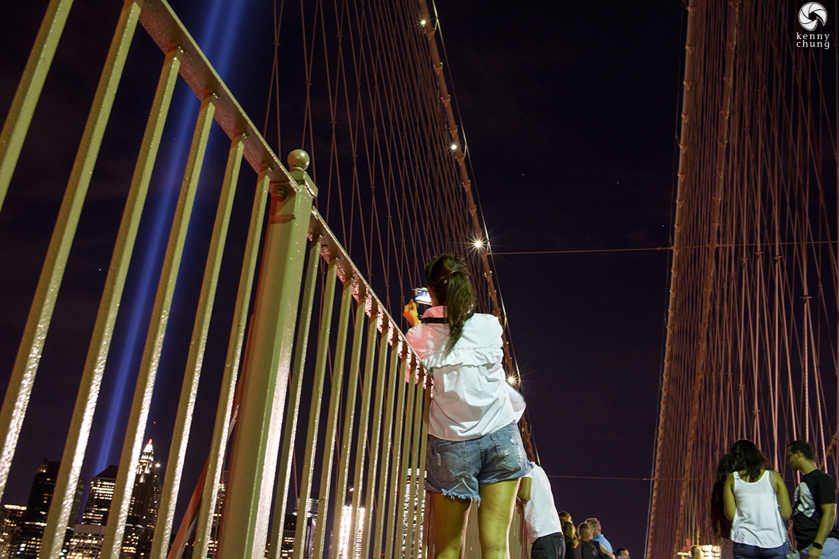 People taking photos of the Tribute in Light 2016 from the Brooklyn Bridge