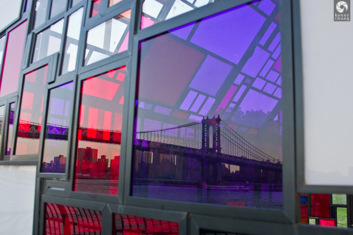 The Manhattan Bridge seen through Tom Fruin's Stained Glass House at Brooklyn Bridge Park